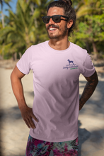 Load image into Gallery viewer, Picture of man wearing a swimsuit and a pink Lucky Labrador shirt on a beach.